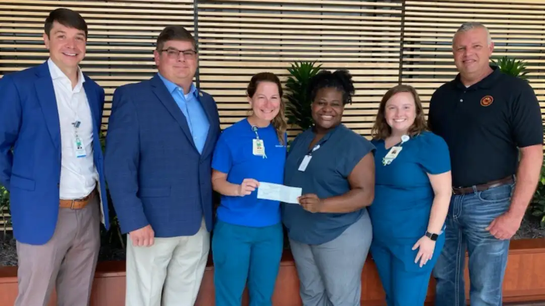 group presentation of donation check